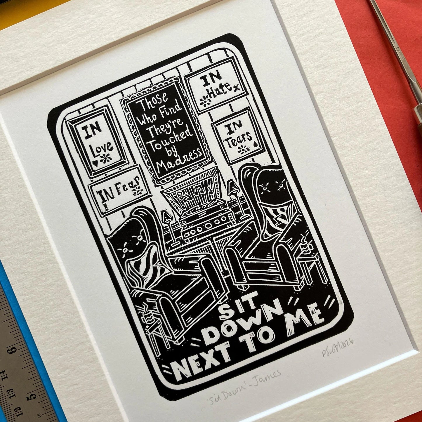 Sit Down by James Black and White Lino Print on a colourful background