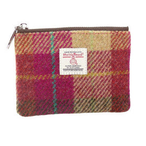 Small Harris Tweed zip pouches in assorted tartan, checked and coloured designs, featuring authentic handwoven Scottish fabric and Harris Tweed Orb labels.