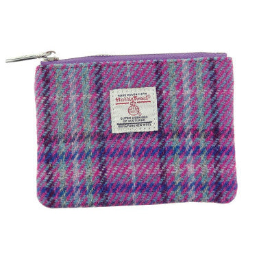 Small Harris Tweed zip pouches in assorted tartan, checked and coloured designs, featuring authentic handwoven Scottish fabric and Harris Tweed Orb labels.