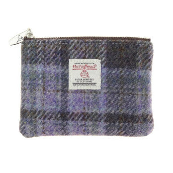 Small Harris Tweed zip pouches in assorted tartan, checked and coloured designs, featuring authentic handwoven Scottish fabric and Harris Tweed Orb labels.