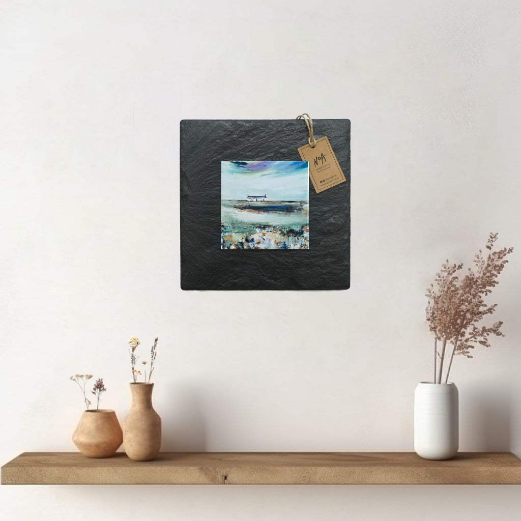 A ceramic tile print of a colourful painting titled 'Spring Days', showing a small house nestled in the Scottish Highlands, available mounted on natural slate or framed.