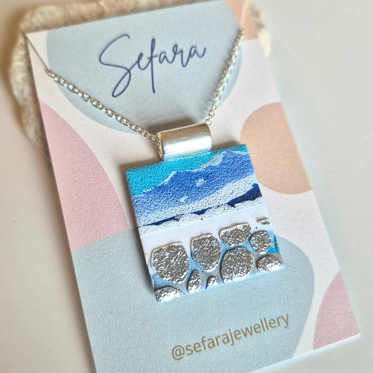 Sefara Jewellery coastal seascape pendant necklaces in circle and square designs, featuring unique 30mm pendants with gold leaf details on silver-plated chains.