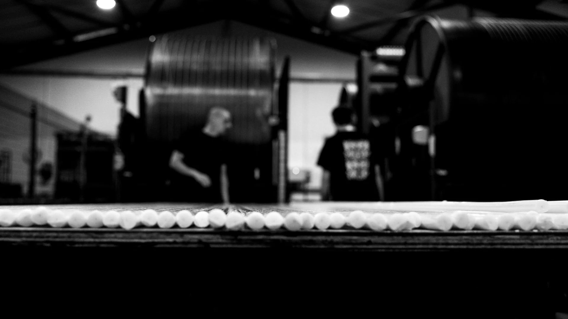 Black and white scene of a person making dinner candles