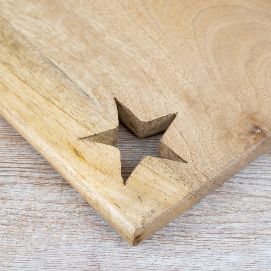 Wooden chopping board with decorative star design for food preparation and serving platters