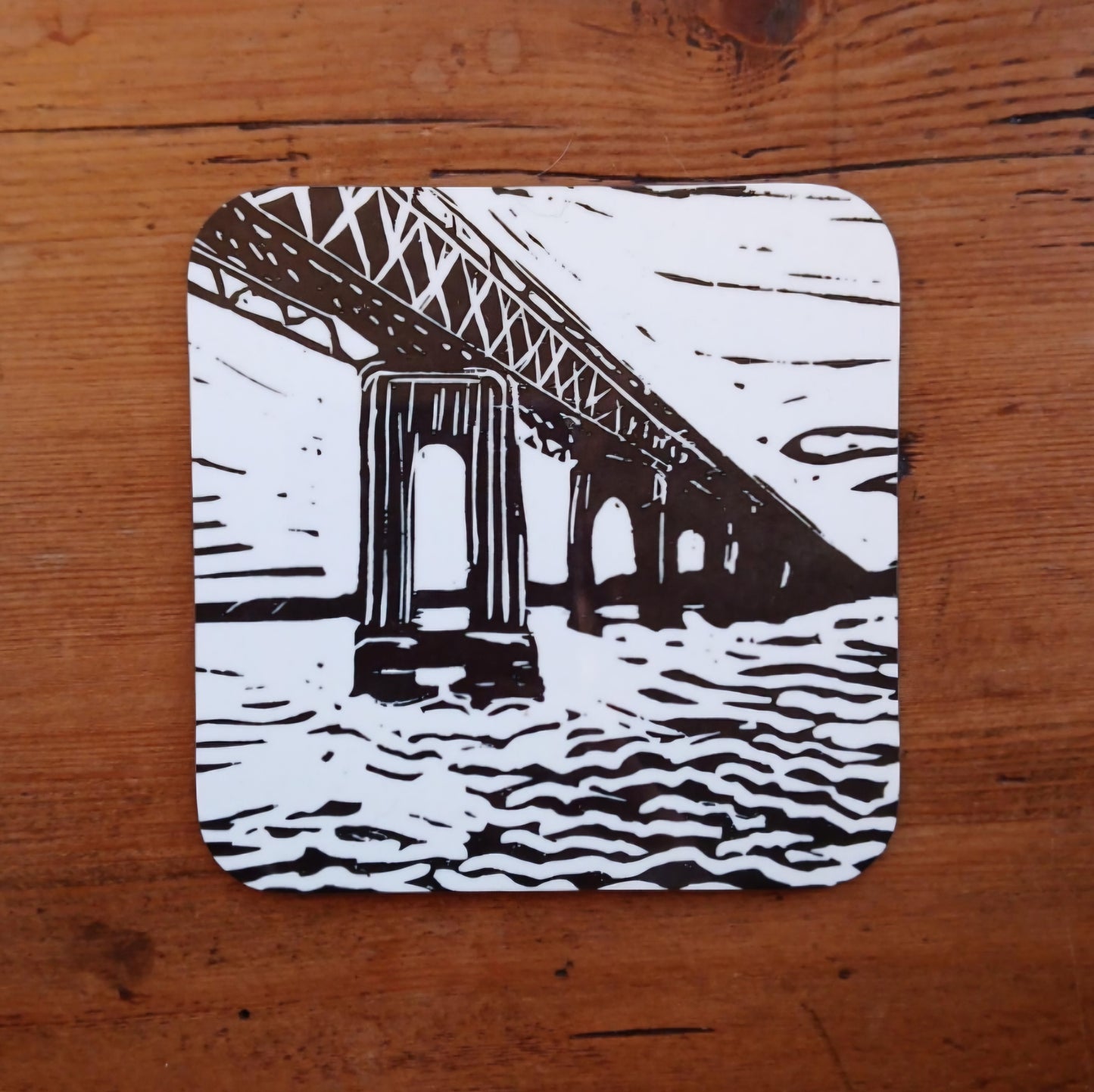 Hardwood coaster with BeeBirds Tay Rail Bridge lino print artwork