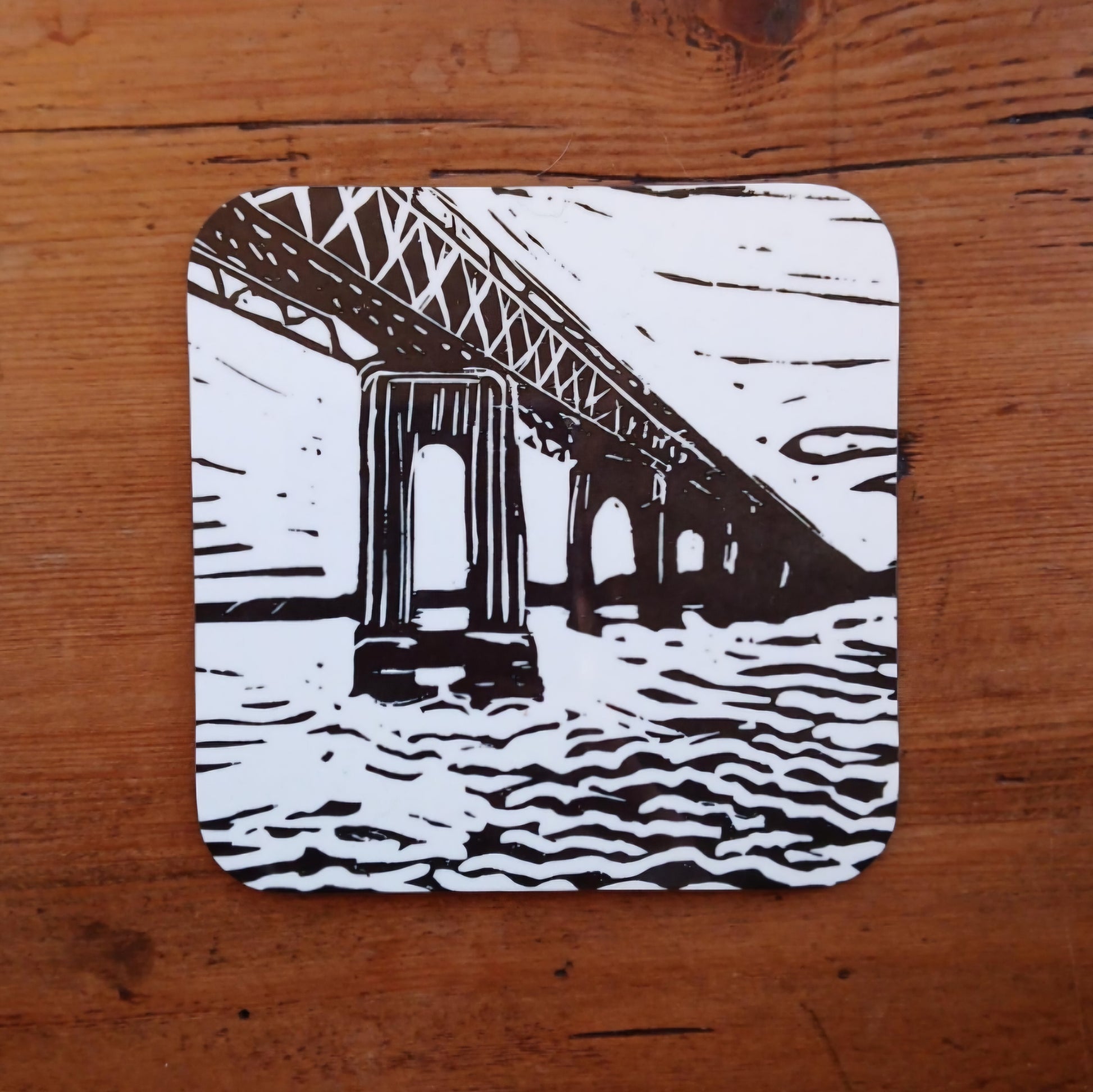 Hardwood coaster with BeeBirds Tay Rail Bridge lino print artwork