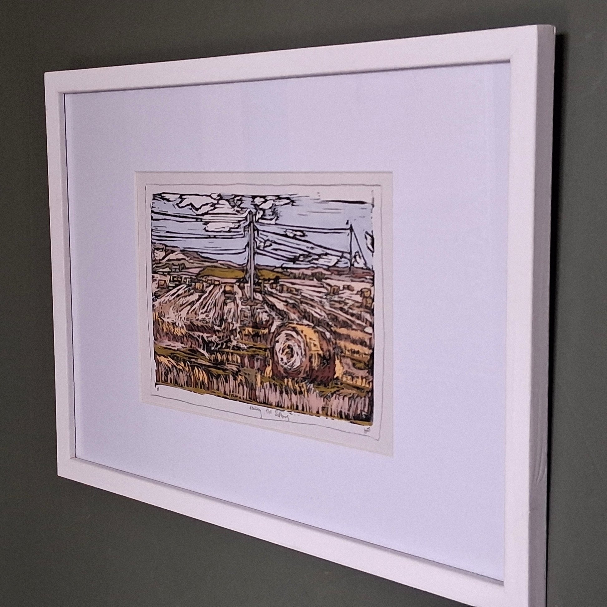 A colourful linocut print by BeeBirds depicting the rolling landscape of Tealing village nestled at the foot of the Sidlaw Hills in Angus, mounted in a white frame.