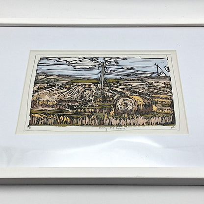 A colourful linocut print by BeeBirds depicting the rolling landscape of Tealing village nestled at the foot of the Sidlaw Hills in Angus, mounted in a white frame.