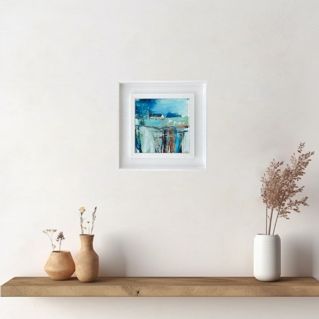 A ceramic tile print of a colourful painting titled 'The Getaway', showing a small house nestled in the Scottish Highlands, available mounted on natural slate or framed.