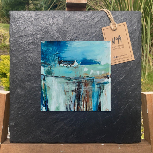 A ceramic tile print of a colourful painting titled 'The Getaway', showing a small house nestled in the Scottish Highlands, available mounted on natural slate or framed.