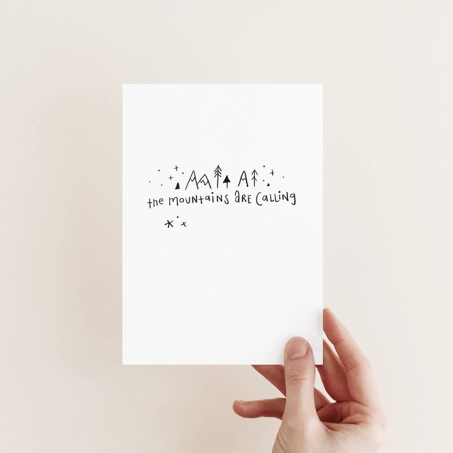 Juniper Press greeting card with 'The Mountains Are Calling' text and minimal mountain-like designs