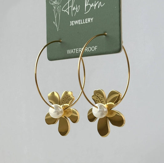 Flax Barn Tropical Flower Dangle Hoop Earrings featuring floral charms with delicate pearl detailing, crafted from PVD-plated stainless steel.