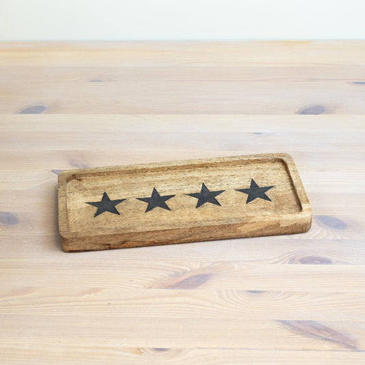 Wooden serving board with decorative black star design for serving cheese, snacks and sharing platters