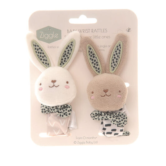 Set of two soft baby rabbit wrist rattles, one white and one beige, with green,  black and white patterns.