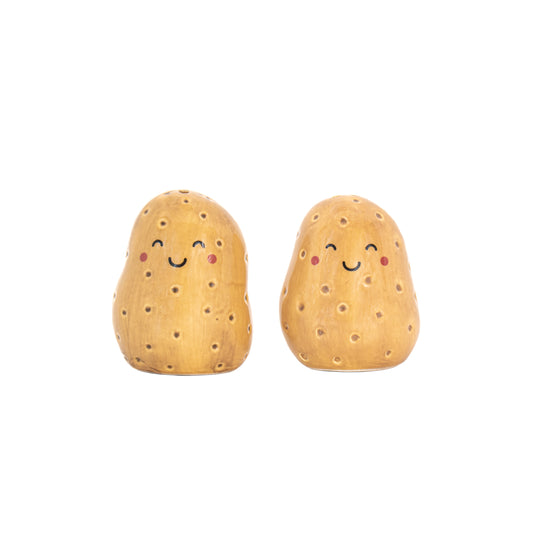 Two potato-shaped salt and pepper shakers with smiling faces on a white background 