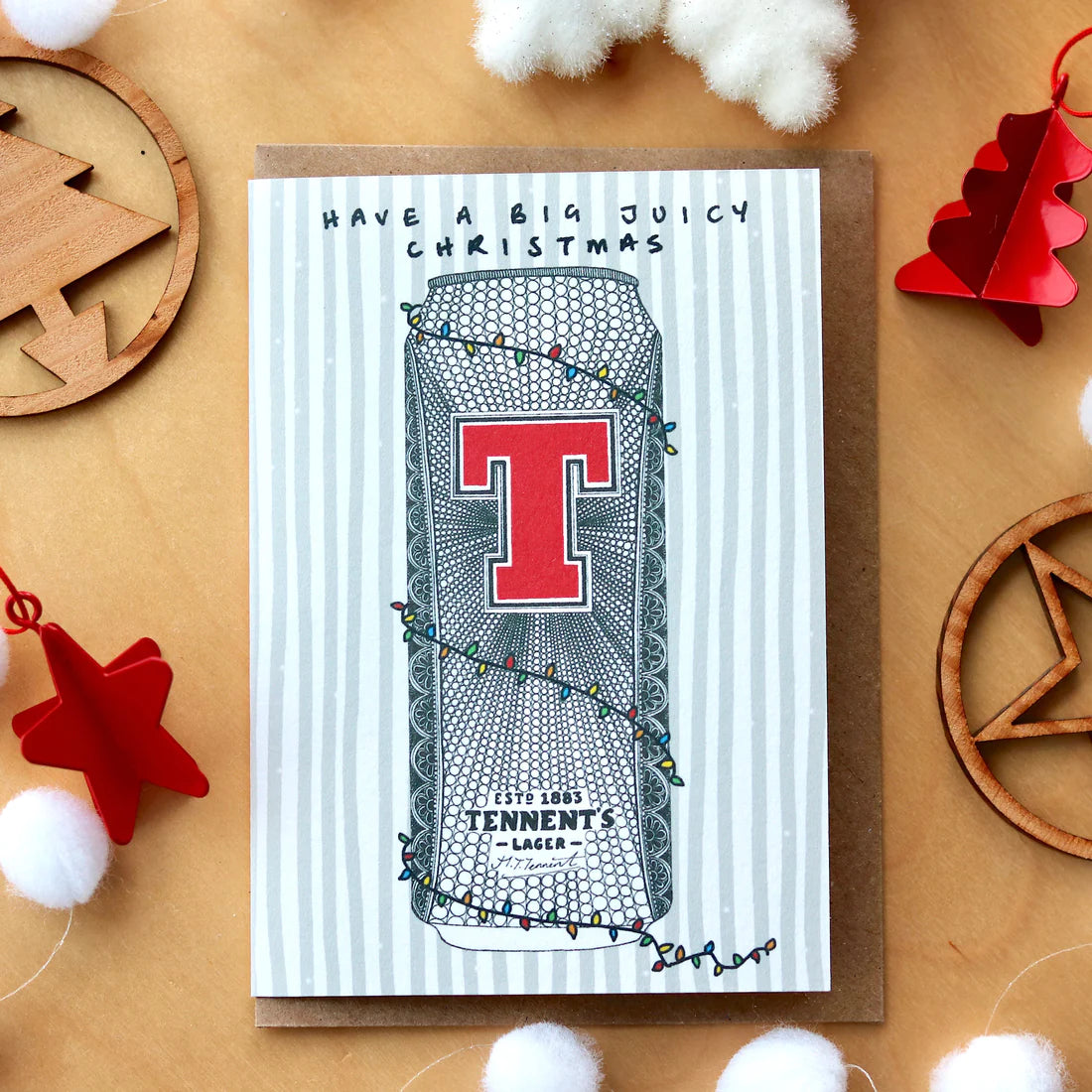 Scottish Tennents lager can Christmas card by Kilo Papa Studio, A6 recyclable design with hand-drawn illustration and Kraft envelope.