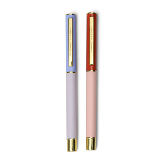 Set of two luxurious colorblocked metal ink pens, one in lavender and one in blush tones, both featuring gold accents and clips.
