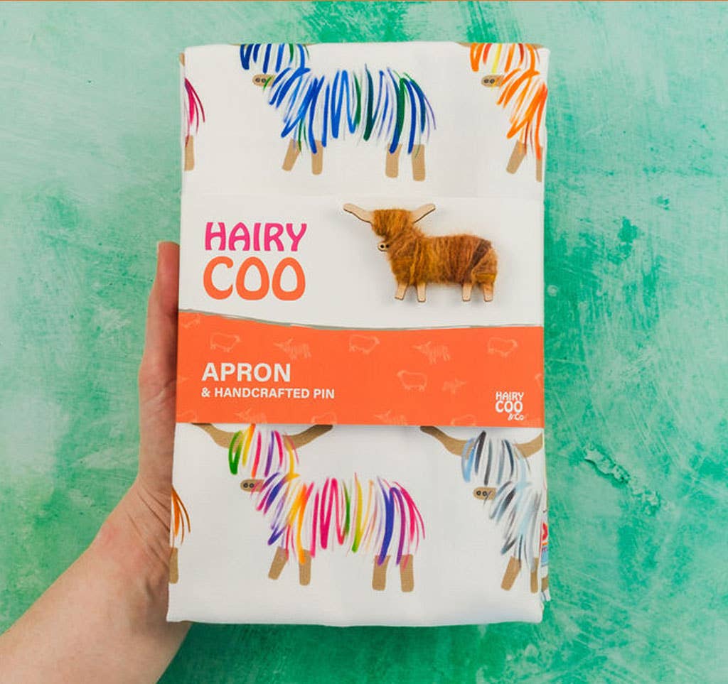 Hairy Coo 100% cotton apron with bright Highland Cow print and handwrapped Hairy Coo pin