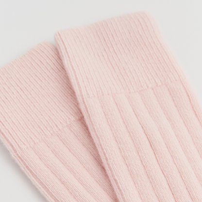 Close-up of pink ribbed knit fabric on Frosting Pink PAIRS Scotland Merino bed socks