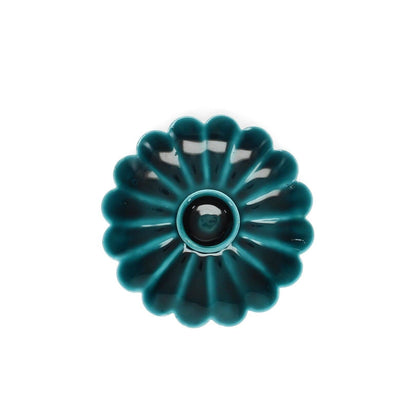 Teal Blue enamel cast metal candle holder with flat flower-shaped pan and foam-padded base