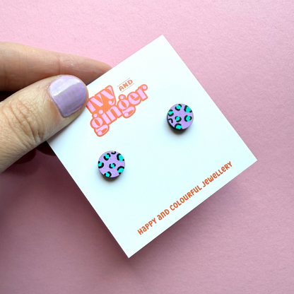 Lilac circle stud earrings with teal and black leopard print, hand painted FSC wood, 10mm, surgical steel posts, bold and colourful design.