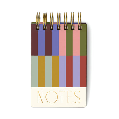A thick, small pocket notepad with a colouful stripe patterned hard cover, featuring 192 lined sheets inside.