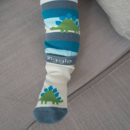 Baby feet wearing cotton baby socks with dinosaur design, anti-slip soles and ribbed cuffs