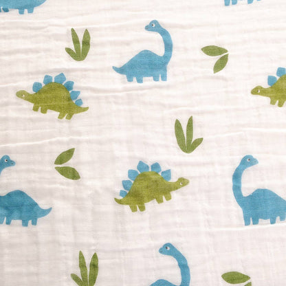 Close up of Ziggle baby swaddle with a dinosaur design