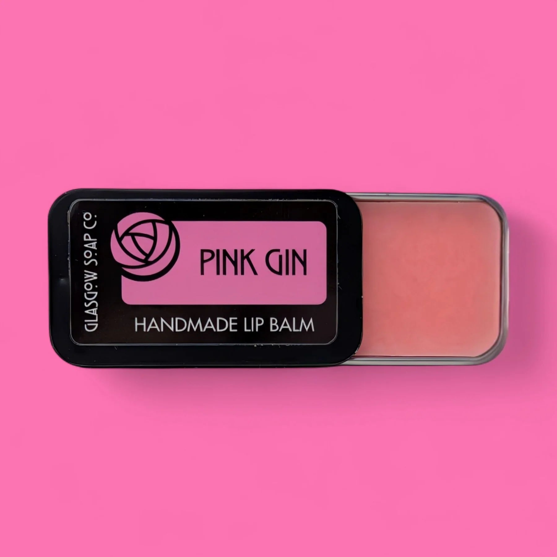 Handmade Pink Gin-flavoured lip balm with coconut oil, shea butter & beeswax. Rich, nourishing, and a cheeky Scottish treat. 15g slide tin.