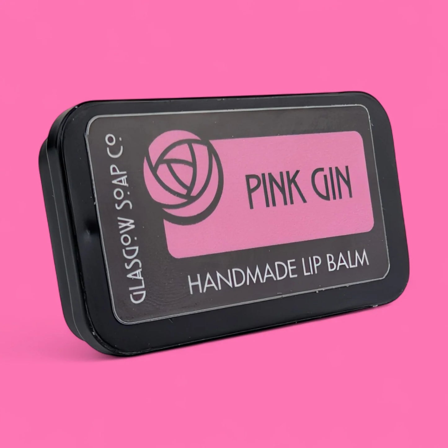 Handmade Pink Gin-flavoured lip balm with coconut oil, shea butter & beeswax. Rich, nourishing, and a cheeky Scottish treat. 15g slide tin.